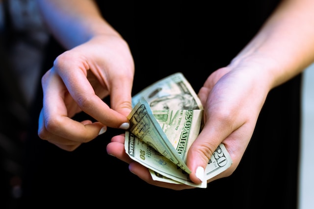 Person holding some cash person holding some cash