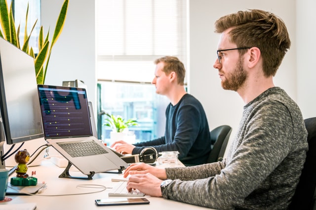 2 men working in an office 2 men working in an office