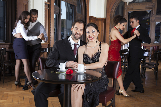 Couple Smiling While Enjoying Tango Performance In Restaurant