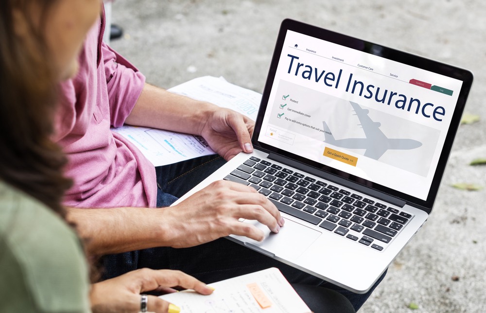 laptop screen with Travel Insurance on it