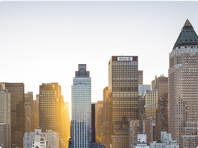 <span>Travel</span> card in <span>USA</span> Sunlight shines between tall buildings of a USA city skyline, highlighting modern skyscrapers against a clear sky.