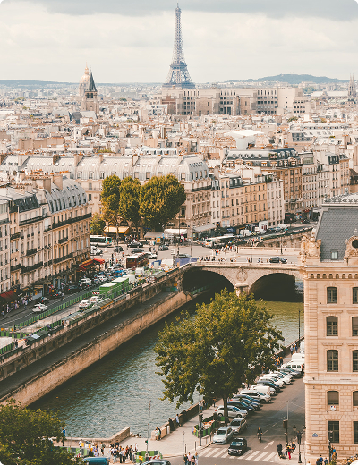 <span>Virtual cards</span> for online and in-store use A view of a city in Europe featuring a river, historic architecture, a bridge, city streets, and a prominent landmark in the background.
