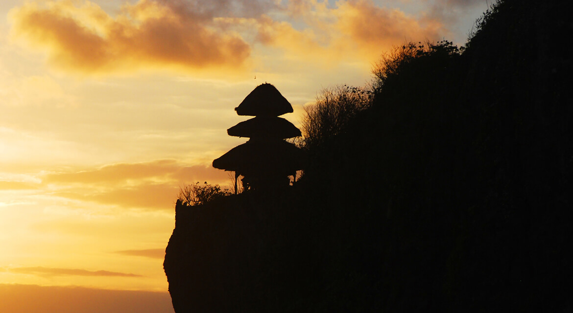 Uluwatu Temple in Bali at sunset—cliffside Hindu shrine with panoramic ocean views and evening Kecak fire dance performance.