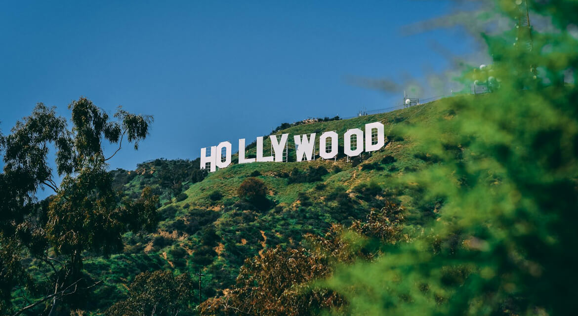 The iconic Hollywood sign perched on sunlit hills in Los Angeles, capturing the city’s blend of entertainment legacy, natural beauty, and vibrant lifestyle for film lovers and beachgoers alike.