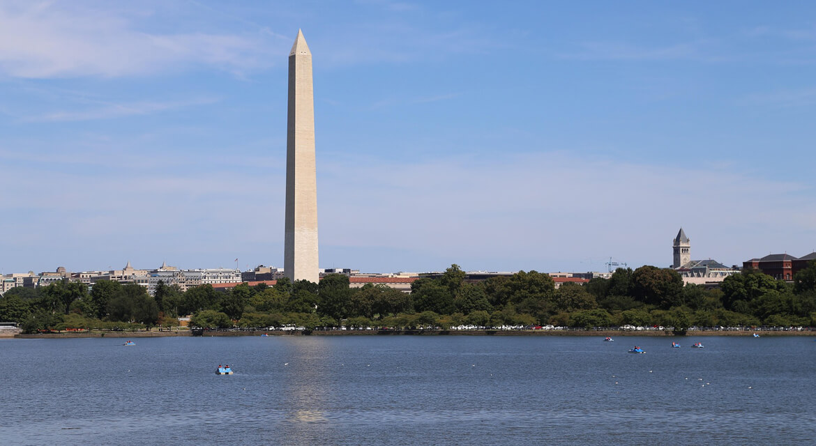 The Washington Monument rising above the Tidal Basin with boats below, capturing the city’s blend of history, leisure, and iconic landmarks.