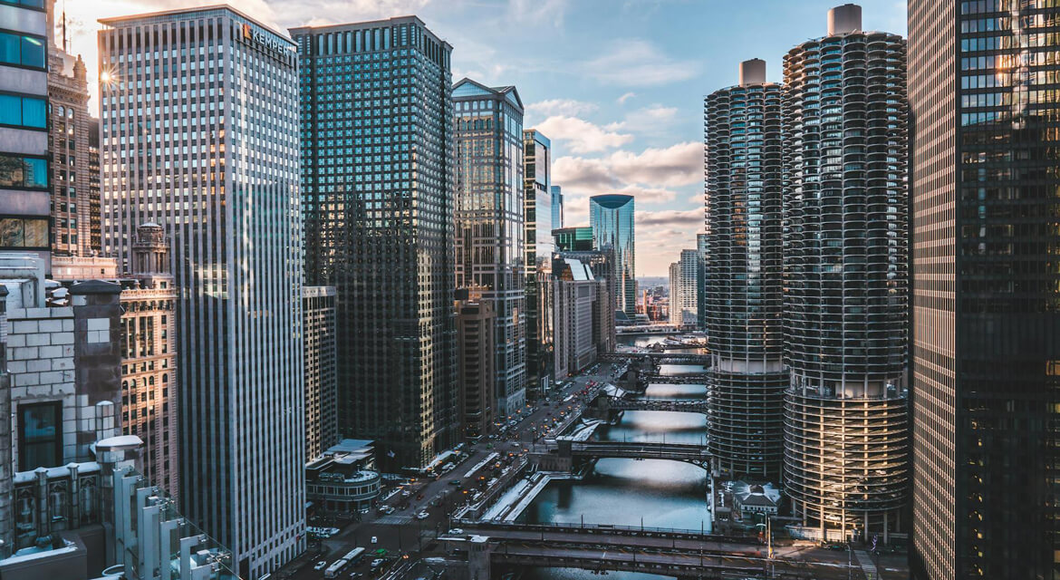 Chicago River winding through skyscrapers and Marina City towers, showcasing the city’s bold architecture and urban energy.
